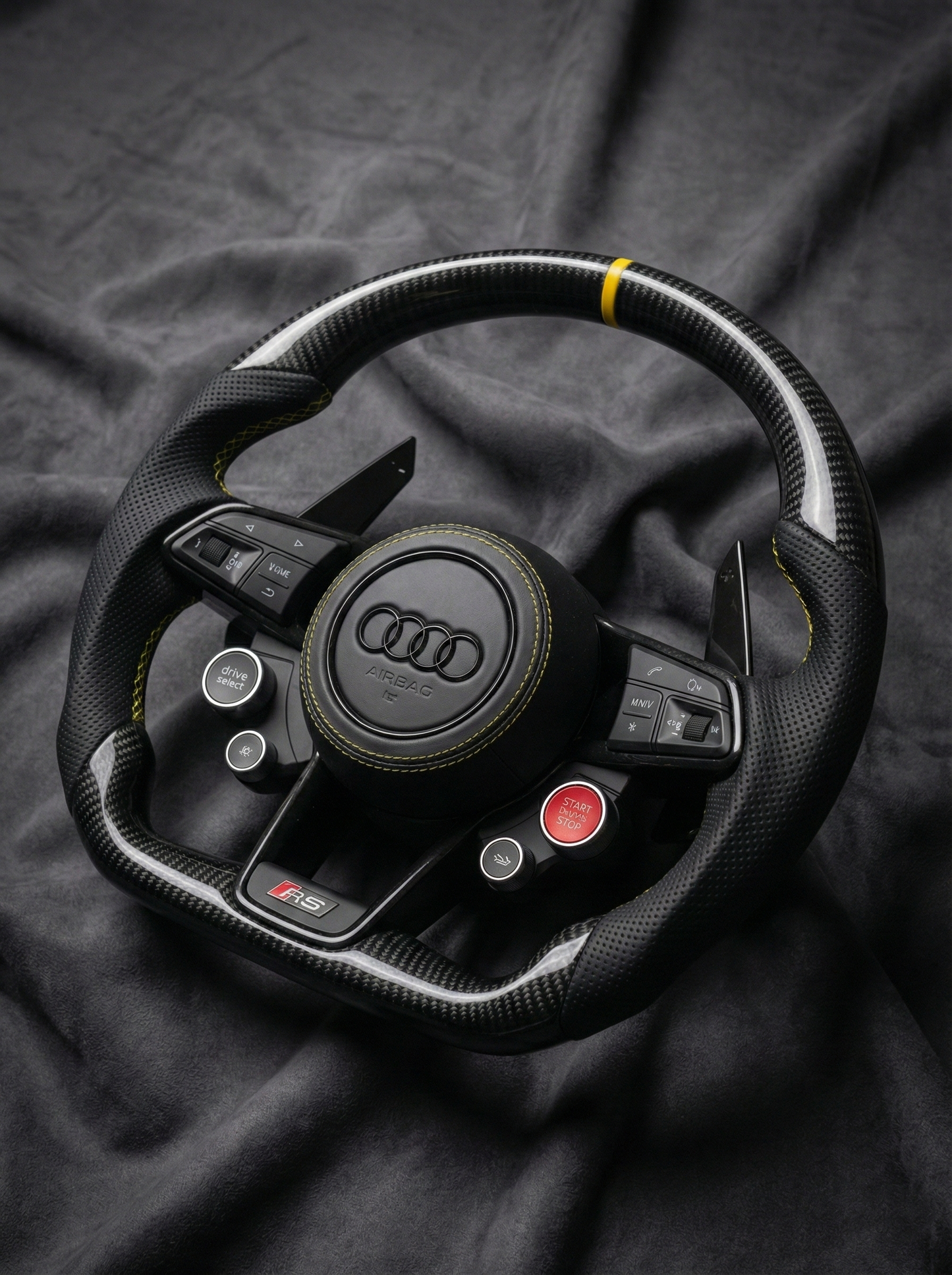 Audi steering wheel on a dark fabric background