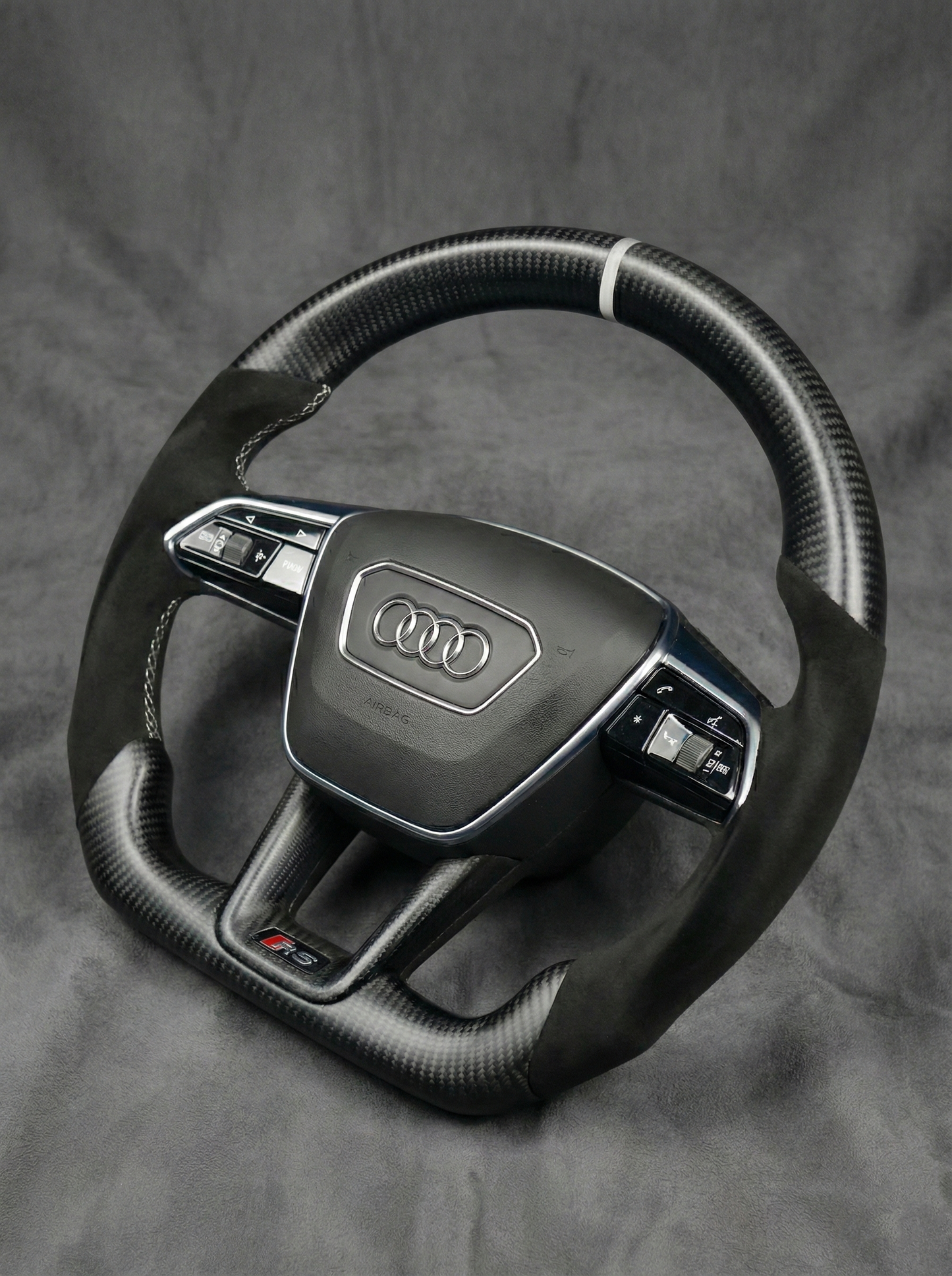 Steering wheel with Audi logo on a gray background