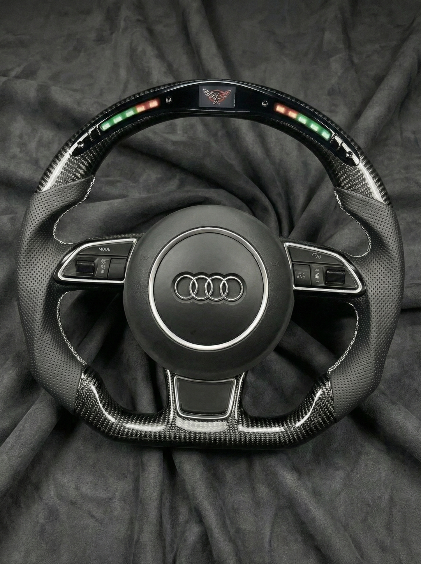 Steering wheel with Audi logo on a dark background