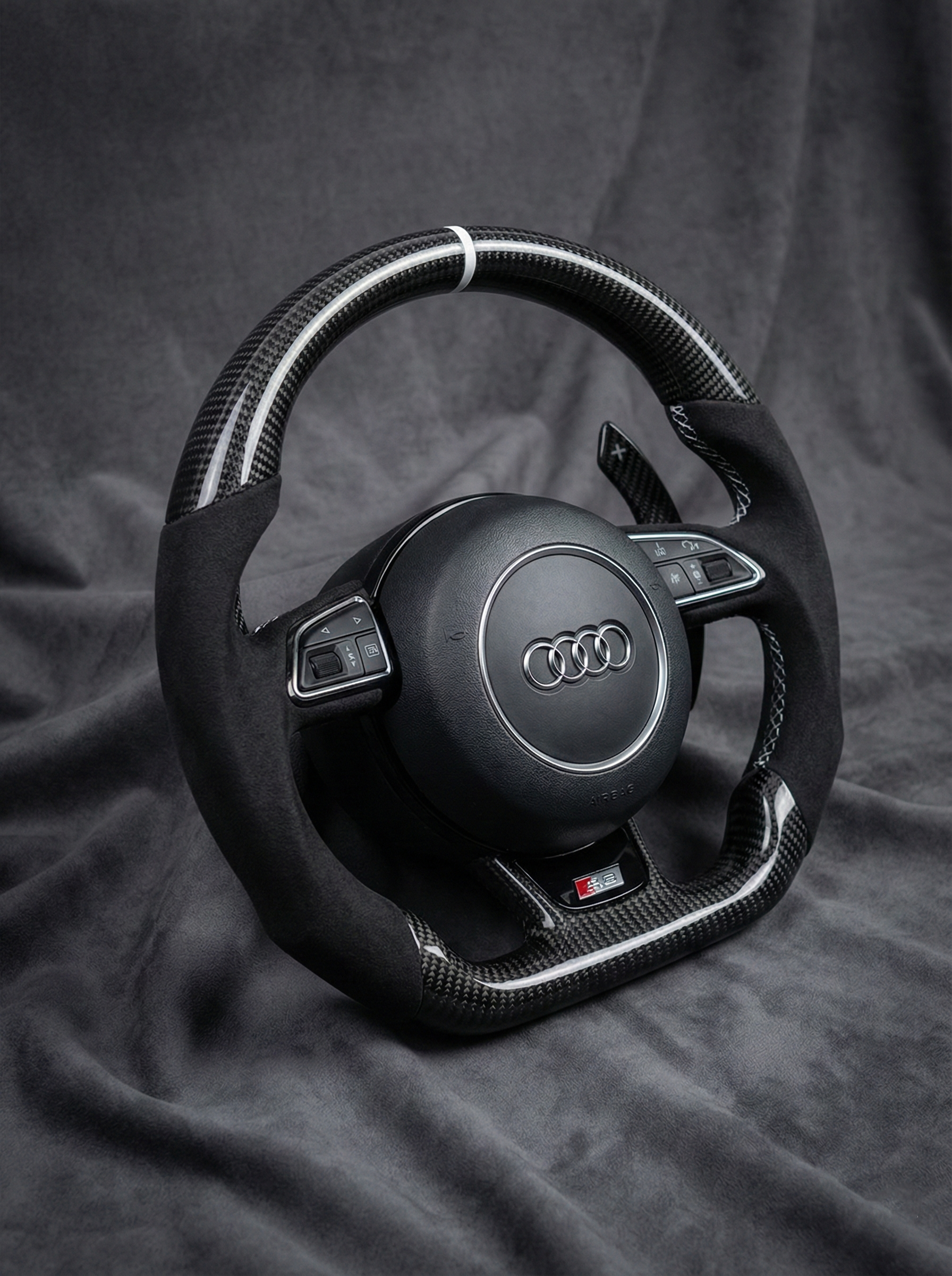 Audi steering wheel on a dark fabric background