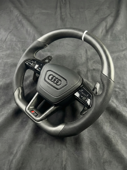 Steering wheel with Audi logo on a gray background