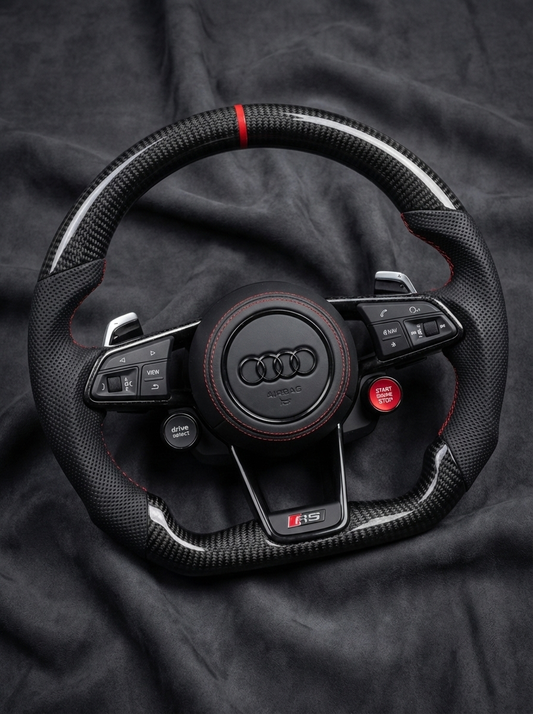 Steering wheel with Audi logo on a dark fabric background