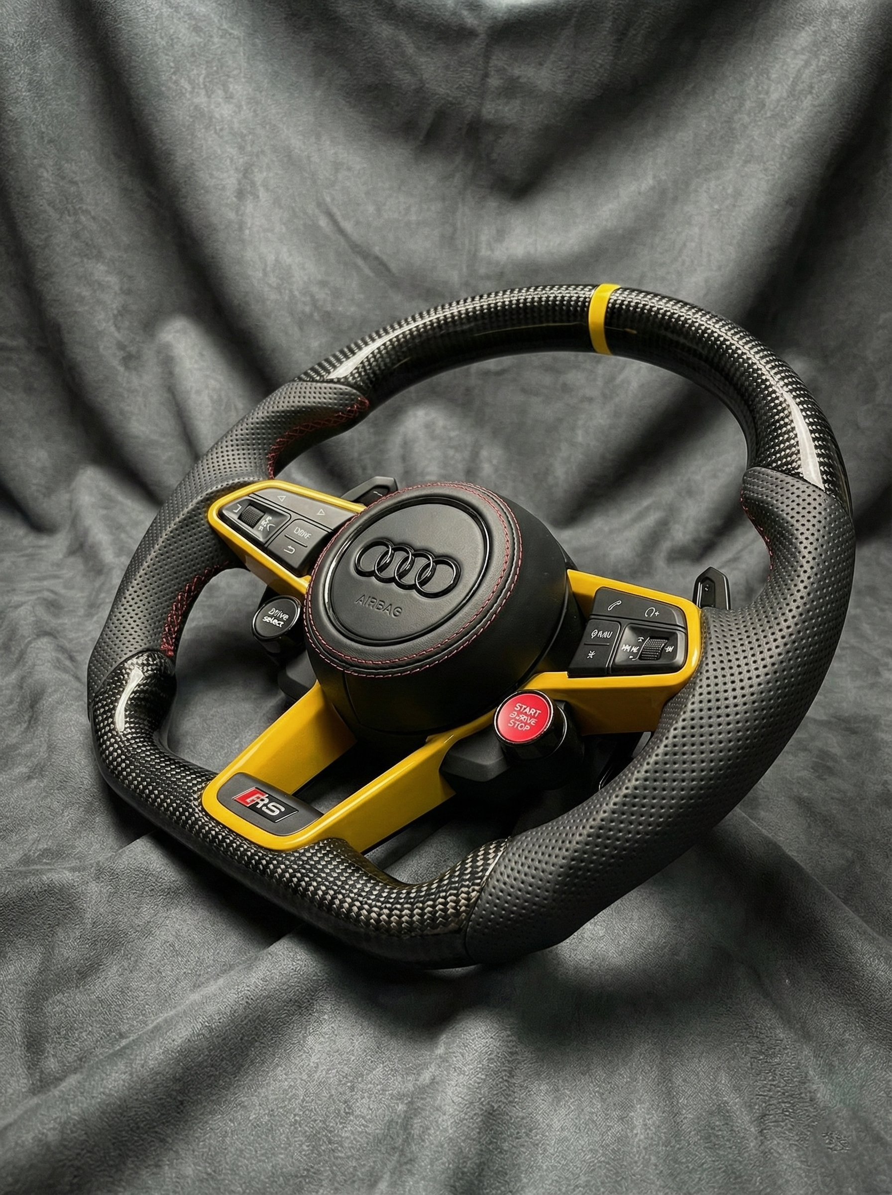 Steering wheel with Audi logo on a gray background
