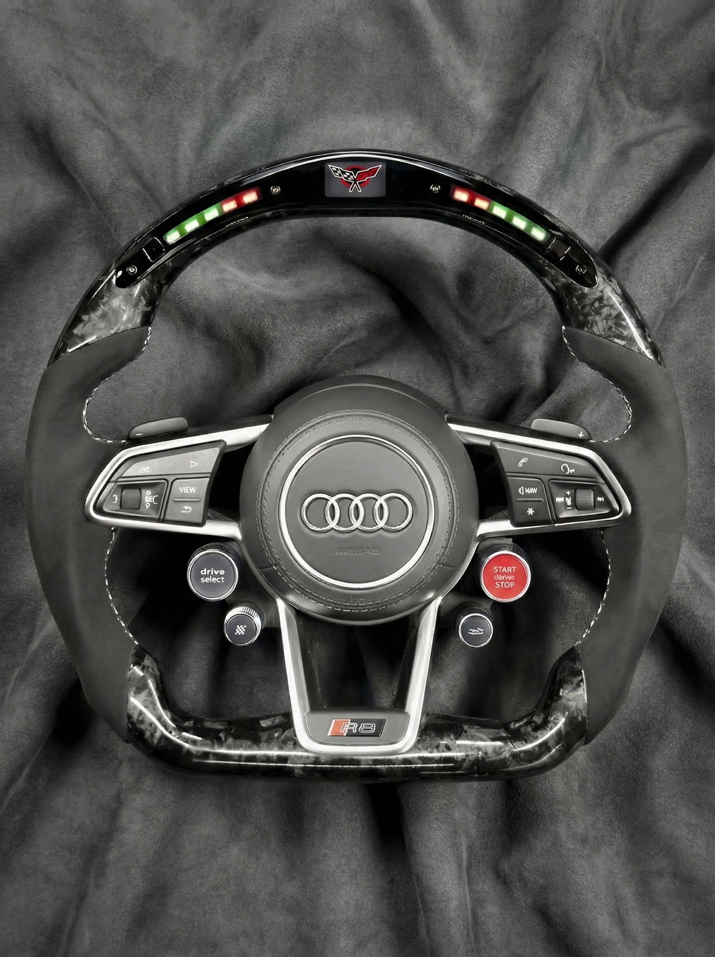 Steering wheel with Audi logo on a gray background