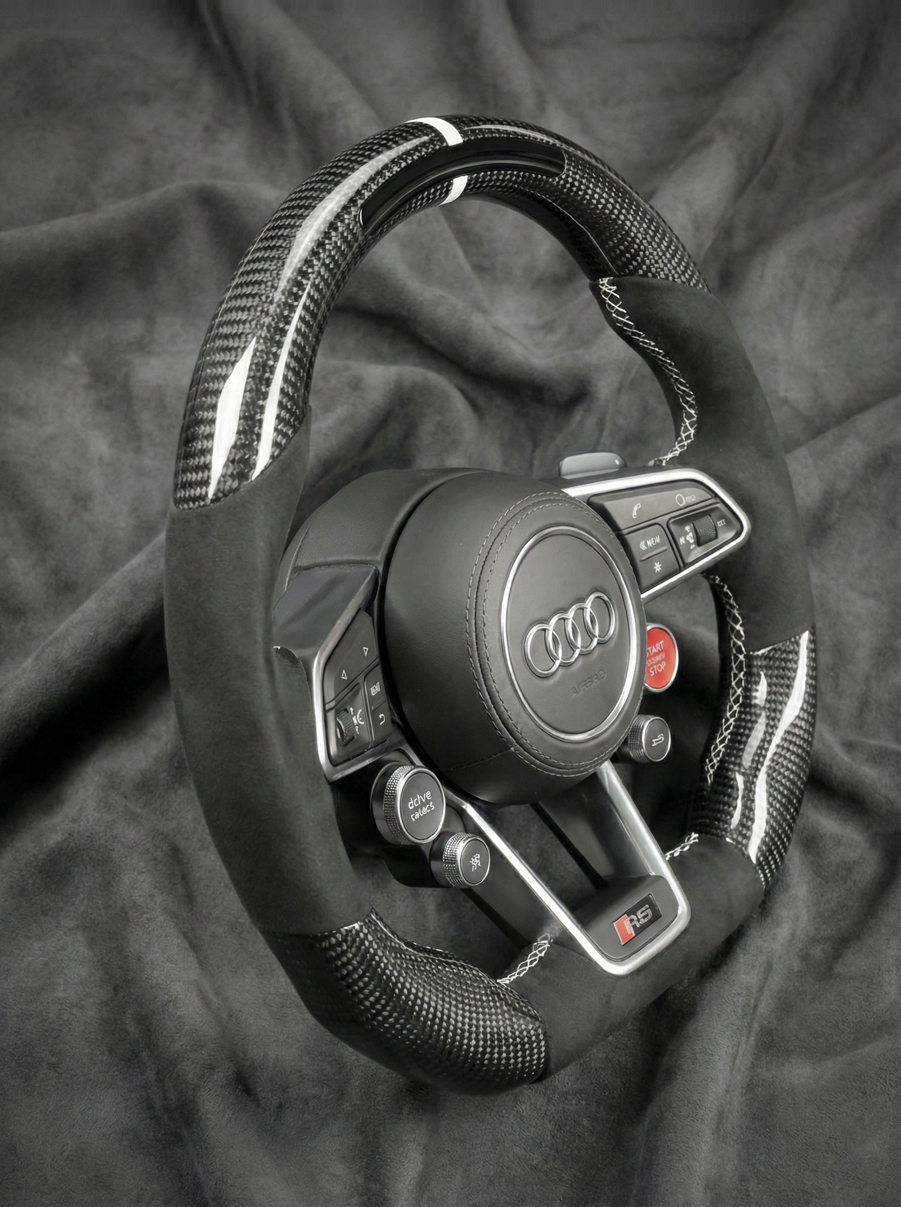 Audi steering wheel on a dark fabric background