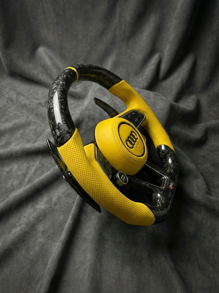 Yellow and black handcuff on a gray fabric background