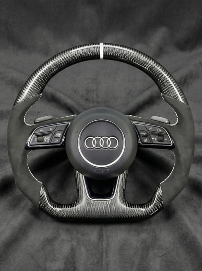 Steering wheel with Audi logo on a dark background