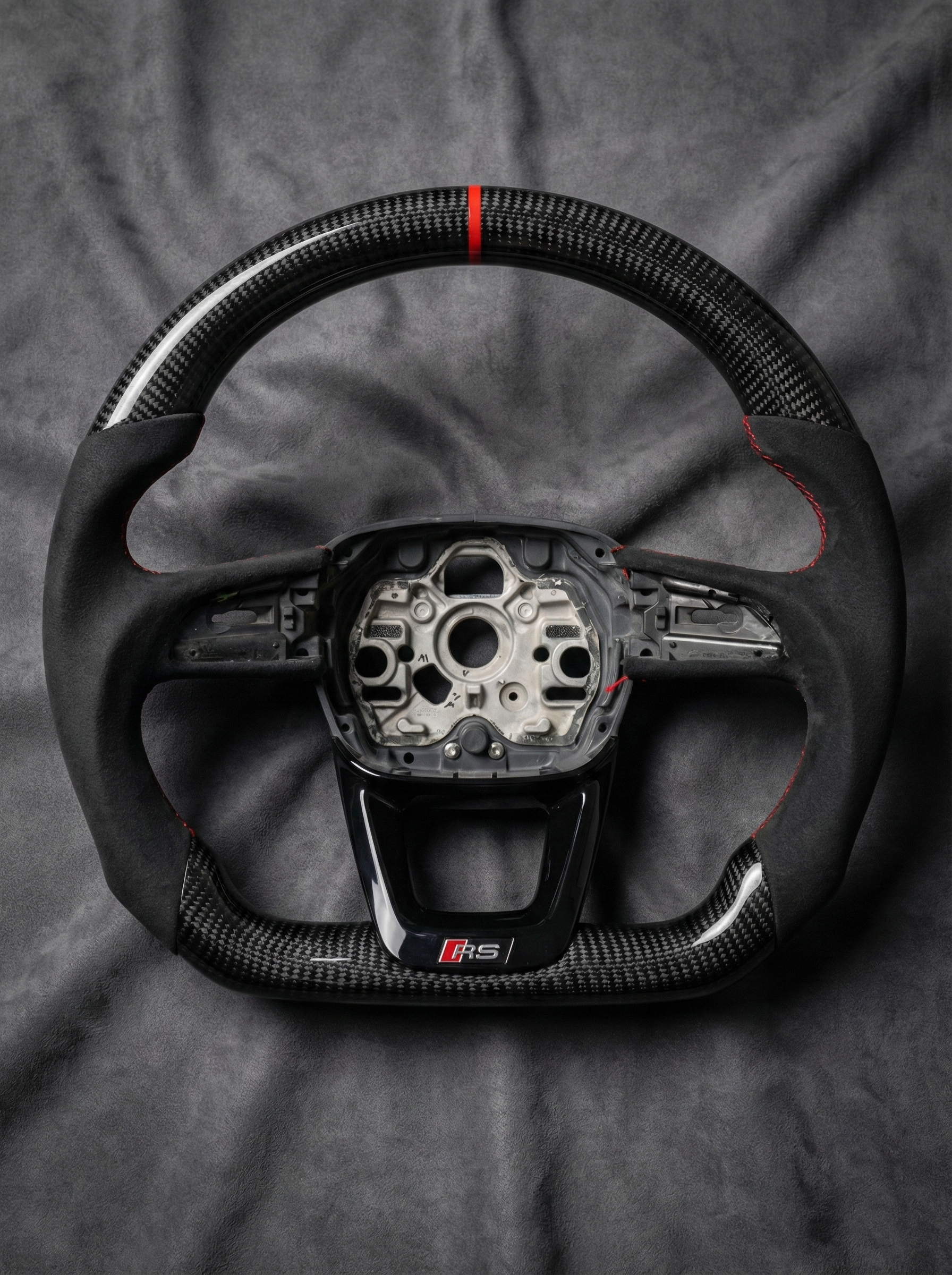 Steering wheel with visible brand logo on a gray background