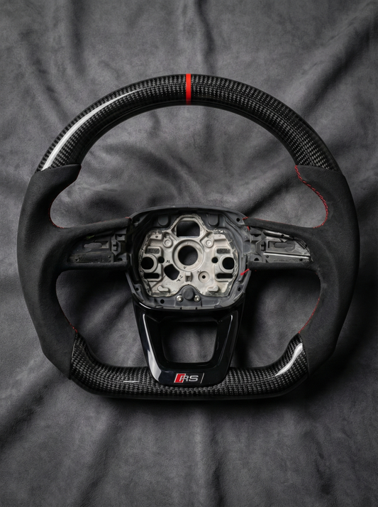 Steering wheel with visible brand logo on a gray background