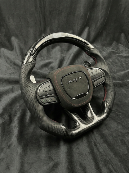 Car steering wheel with SRT logo on a dark fabric background