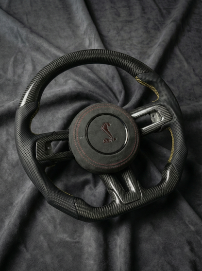 Steering wheel with a logo on a dark fabric background