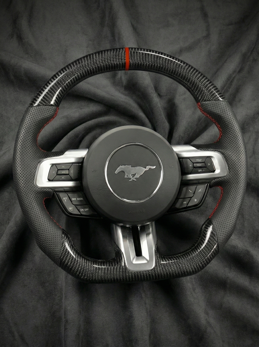 Steering wheel with Mustang logo on a dark fabric background