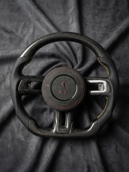 Steering wheel with a logo on a dark fabric background