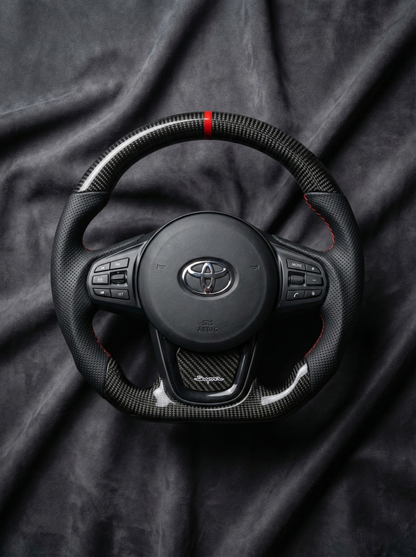 Steering wheel with Toyota logo on a dark fabric background