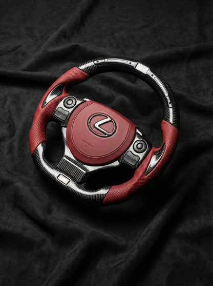 Red and black steering wheel with Lexus logo on a dark fabric background