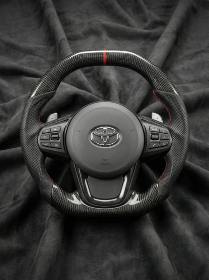 Steering wheel with Toyota logo on a dark fabric background
