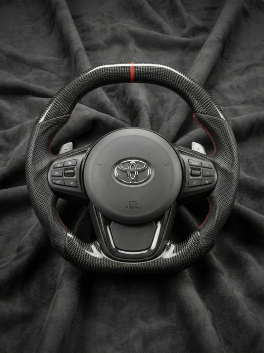 Steering wheel with Toyota logo on a dark fabric background